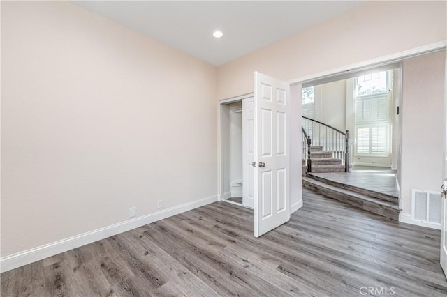 unfurnished bedroom with a closet and light hardwood / wood-style flooring