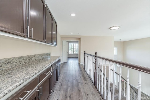 corridor with light hardwood / wood-style flooring