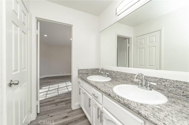 bathroom featuring hardwood / wood-style flooring and vanity