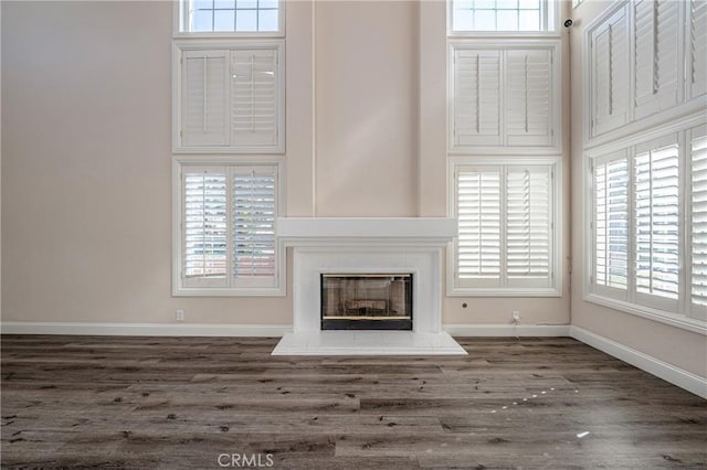 unfurnished living room with dark hardwood / wood-style flooring