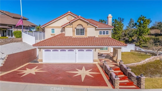 mediterranean / spanish-style house featuring a garage and a front yard