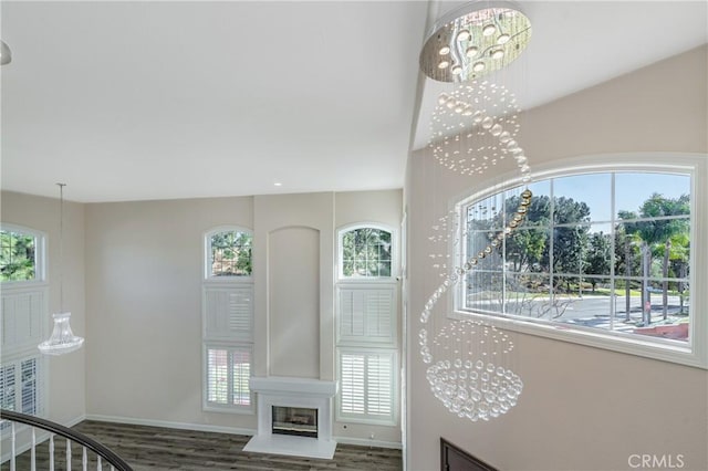 stairs featuring hardwood / wood-style floors and a chandelier