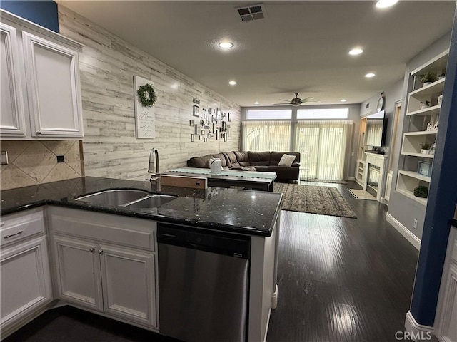 kitchen with white cabinetry, dishwasher, sink, dark hardwood / wood-style flooring, and kitchen peninsula