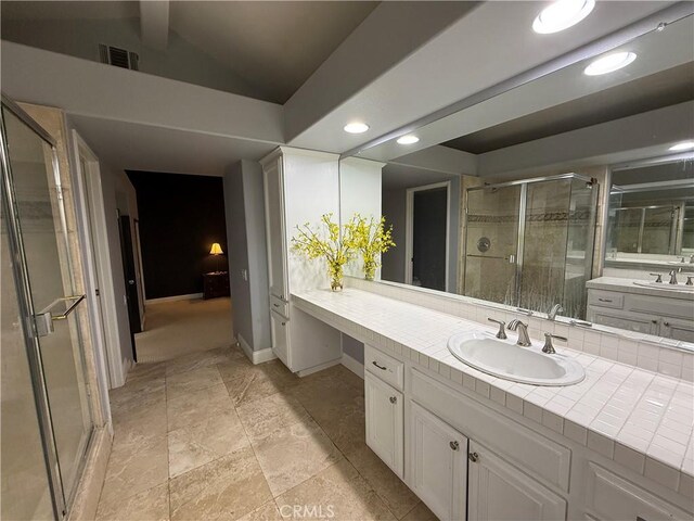 bathroom with vanity, an enclosed shower, and vaulted ceiling with beams