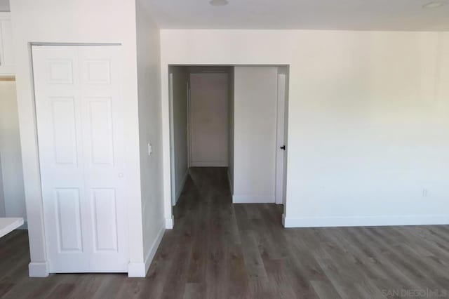 hallway with dark hardwood / wood-style floors