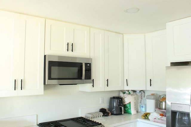 kitchen with white cabinetry and appliances with stainless steel finishes