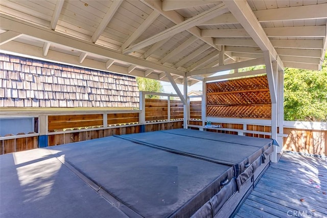 deck featuring a covered hot tub