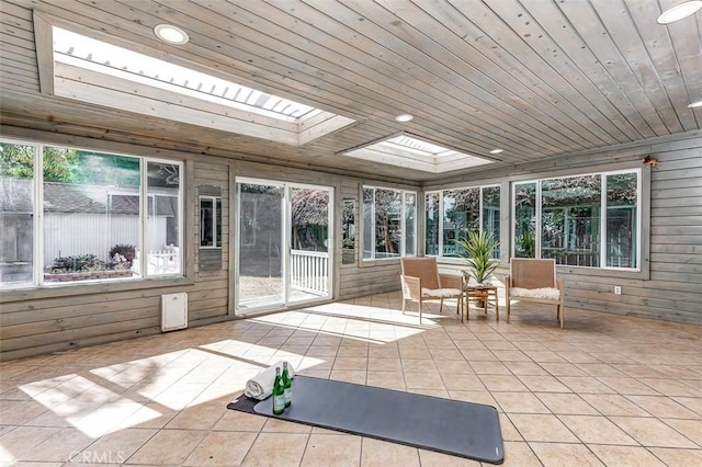 sunroom with a skylight and wooden ceiling