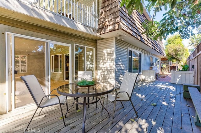 wooden terrace with fence and outdoor dining space