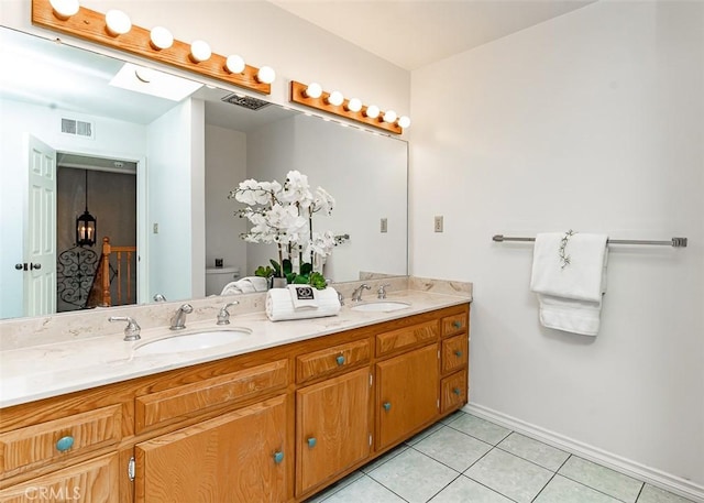 bathroom featuring visible vents, a sink, toilet, and tile patterned floors