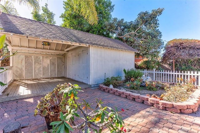 view of outbuilding with fence