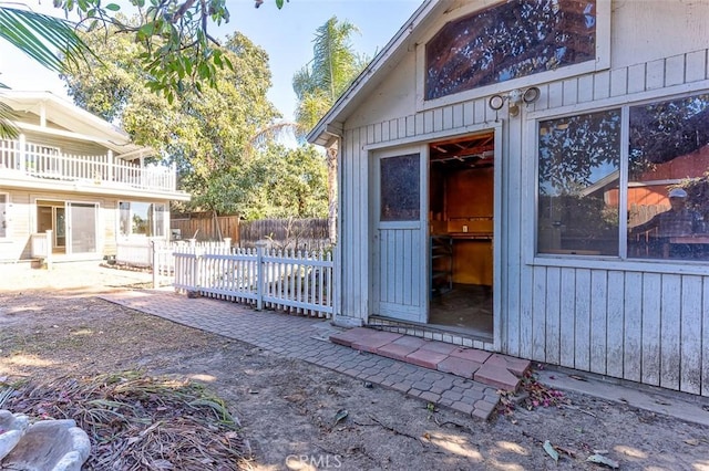 property entrance with a patio and fence