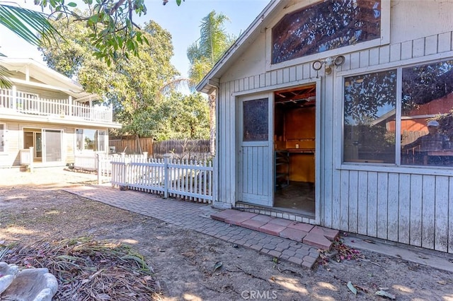 view of outbuilding featuring fence