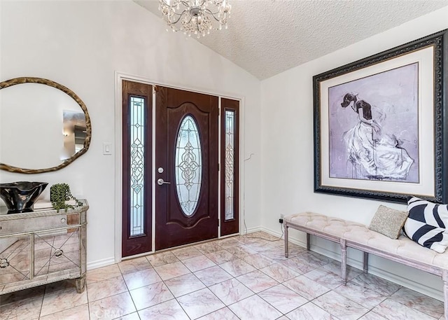 foyer entrance featuring vaulted ceiling, a textured ceiling, baseboards, and an inviting chandelier