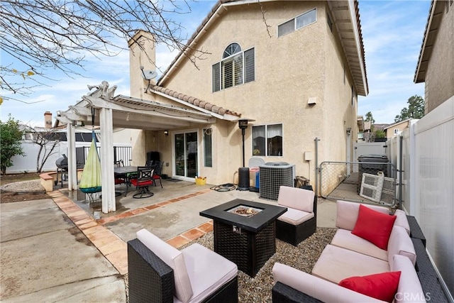 rear view of house with an outdoor living space with a fire pit, central AC unit, and a patio area