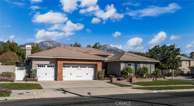 view of front of house featuring a mountain view and a garage