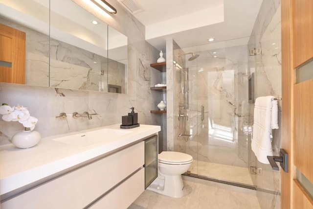 bathroom featuring vanity, toilet, and a shower with shower door