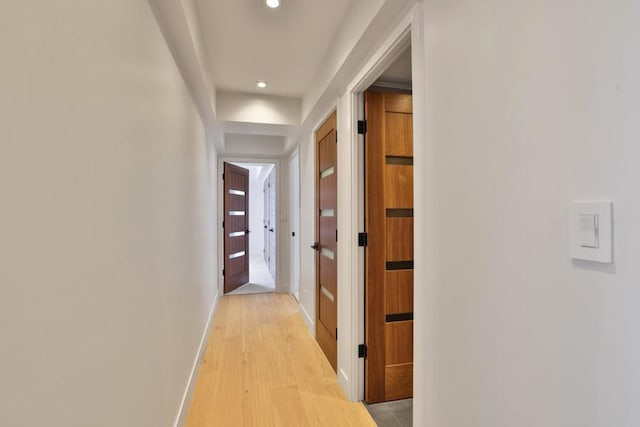 corridor with light hardwood / wood-style flooring