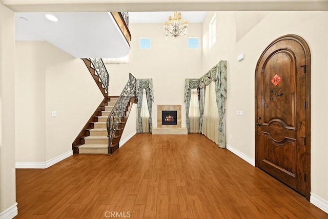 entrance foyer with an inviting chandelier and wood-type flooring