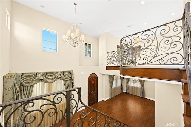 interior space featuring dark hardwood / wood-style flooring and a notable chandelier