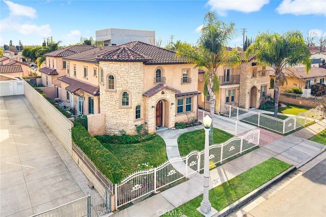 518 W Bencamp St, San Gabriel, CA 91776 - mediterranean / spanish home with stone siding, a gate, stucco siding, a fenced front yard, and a tile roof