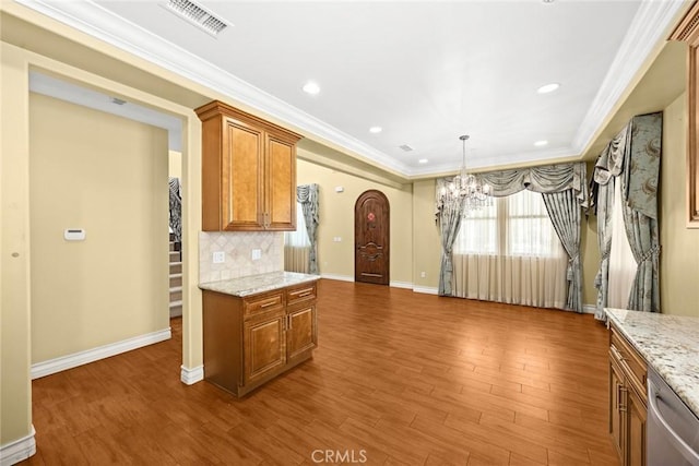 kitchen featuring dishwasher, backsplash, light stone countertops, dark hardwood / wood-style flooring, and a chandelier