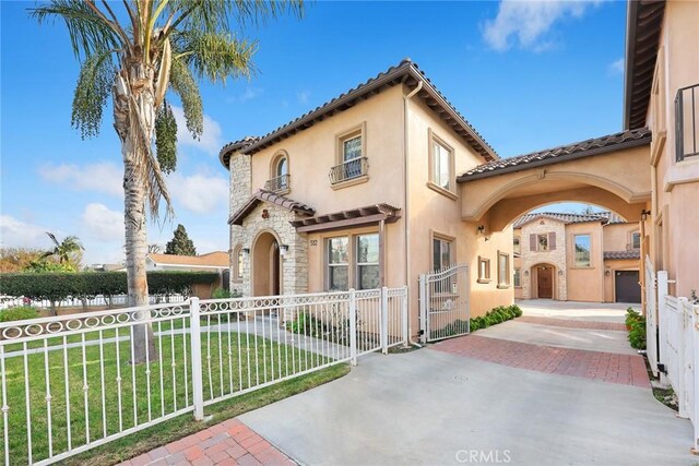518 W Bencamp St, San Gabriel, CA 91776 - mediterranean / spanish-style home with a gate, a fenced front yard, stone siding, and stucco siding