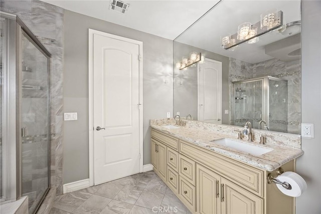 bathroom with vanity and a shower with shower door