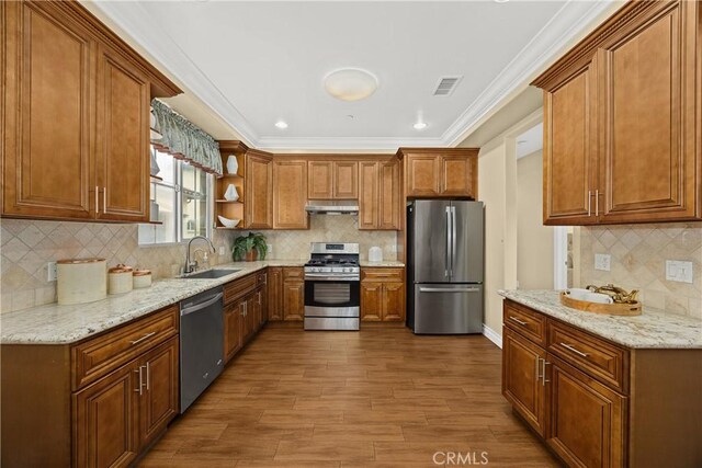 518 W Bencamp St, San Gabriel, CA 91776 - kitchen with appliances with stainless steel finishes, under cabinet range hood, open shelves, brown cabinets, and decorative backsplash
