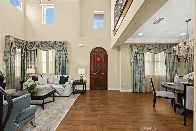 518 W Bencamp St, San Gabriel, CA 91776 - entrance foyer featuring plenty of natural light, a chandelier, wood finished floors, a towering ceiling, and ornamental molding