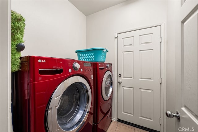 laundry room featuring light tile patterned floors and washing machine and dryer