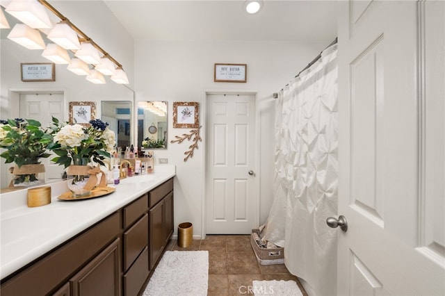 bathroom featuring vanity, tile patterned flooring, and walk in shower