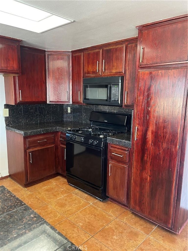 kitchen featuring dark stone countertops, light tile patterned floors, backsplash, and black appliances