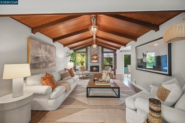 living room with wooden ceiling, a fireplace, wood-type flooring, and vaulted ceiling with beams