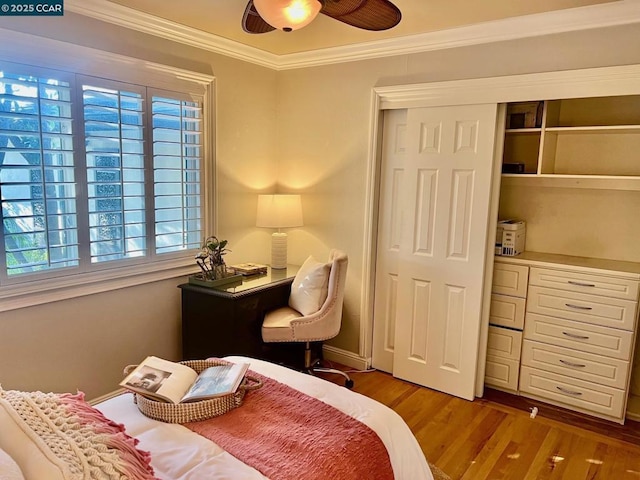 bedroom featuring multiple windows, crown molding, hardwood / wood-style floors, and ceiling fan