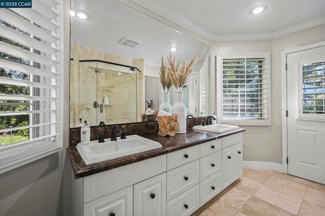 bathroom with vanity, crown molding, tile patterned floors, and walk in shower