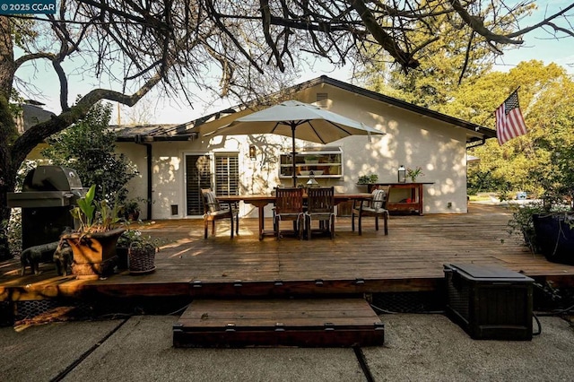 wooden terrace featuring a grill