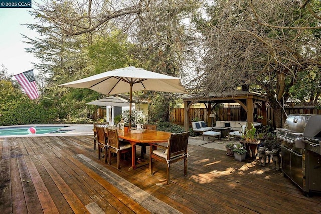 wooden deck featuring a gazebo, area for grilling, an outdoor hangout area, and a fenced in pool