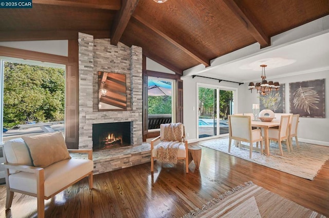 interior space with wood ceiling, a notable chandelier, wood-type flooring, lofted ceiling with beams, and a stone fireplace