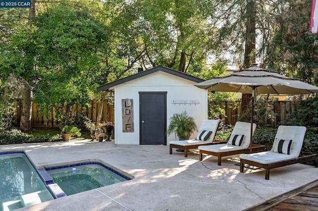 view of pool with a shed, a patio area, and an in ground hot tub