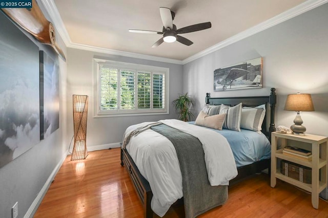 bedroom with crown molding, ceiling fan, and wood-type flooring