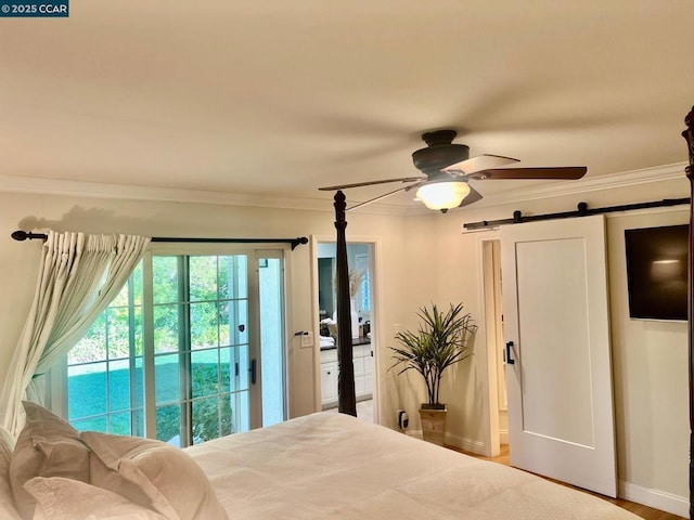 bedroom with access to outside, ornamental molding, ceiling fan, a barn door, and hardwood / wood-style floors