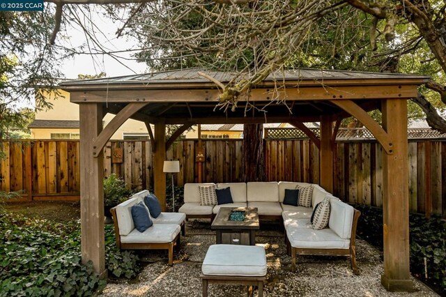 view of patio / terrace featuring a gazebo and an outdoor living space with a fire pit