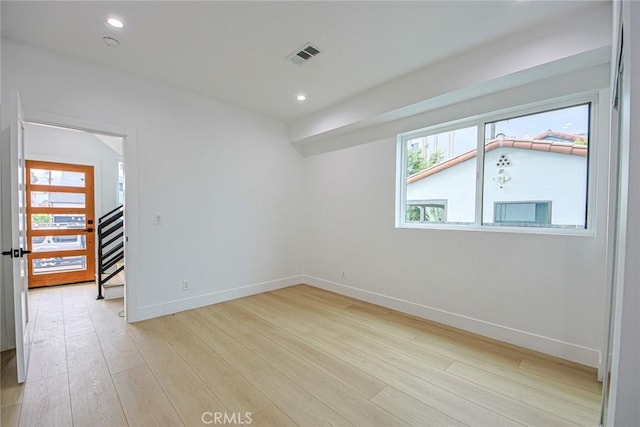 spare room featuring light wood-type flooring