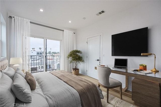 bedroom featuring access to exterior and light wood-type flooring