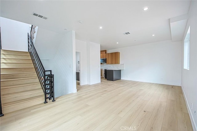 unfurnished living room with light wood-type flooring