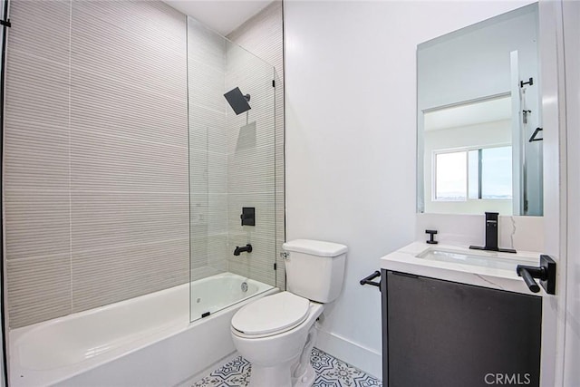 full bathroom featuring tiled shower / bath, vanity, and toilet