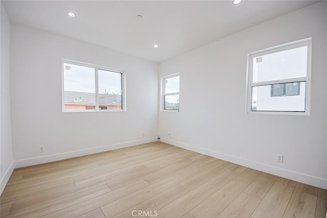 spare room with light wood-type flooring