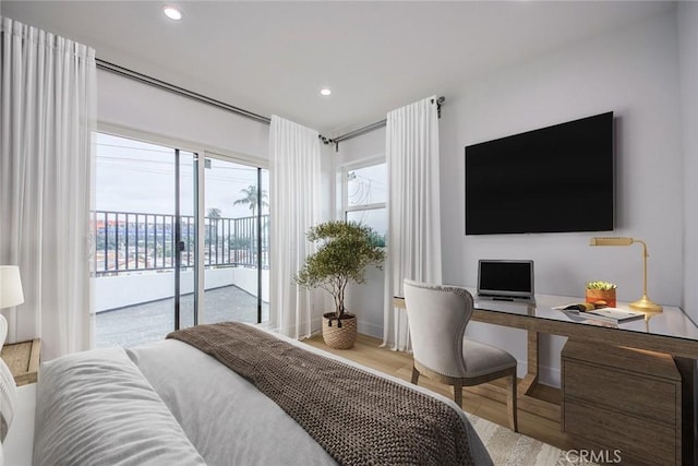 bedroom with access to exterior and light wood-type flooring