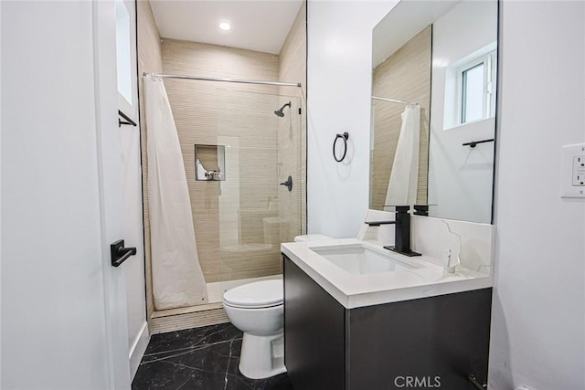 bathroom with vanity, curtained shower, and toilet